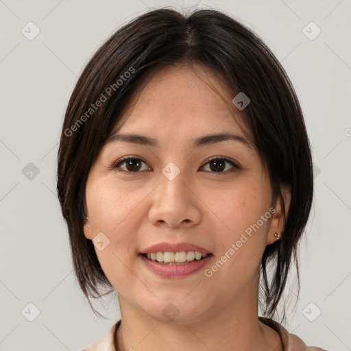 Joyful asian young-adult female with medium  brown hair and brown eyes