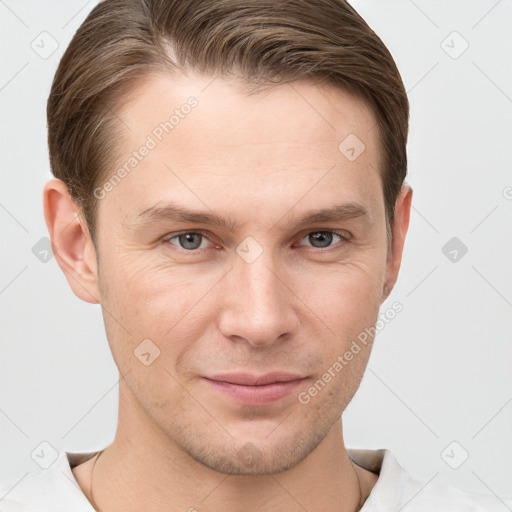 Joyful white young-adult male with short  brown hair and grey eyes