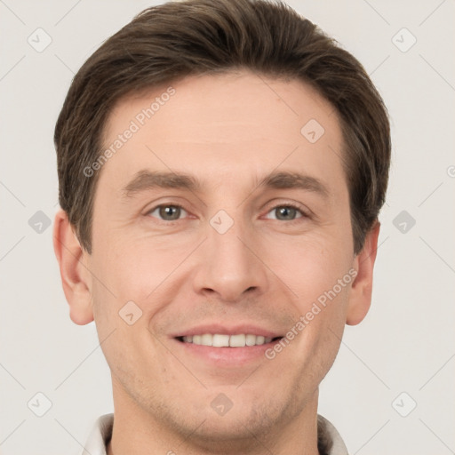 Joyful white young-adult male with short  brown hair and grey eyes