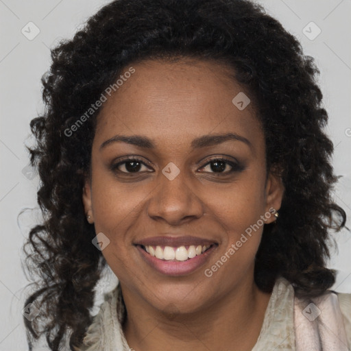 Joyful black young-adult female with long  brown hair and brown eyes