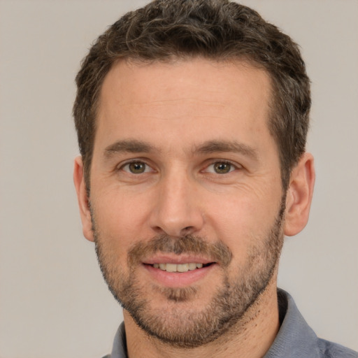 Joyful white adult male with short  brown hair and brown eyes