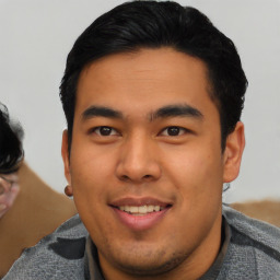 Joyful asian young-adult male with short  black hair and brown eyes