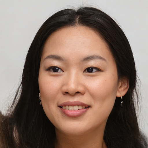 Joyful asian young-adult female with long  brown hair and brown eyes
