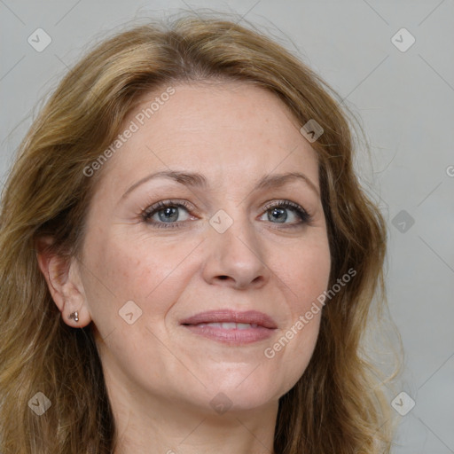 Joyful white adult female with long  brown hair and brown eyes