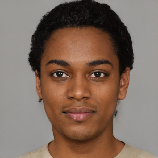 Joyful black young-adult female with short  black hair and brown eyes