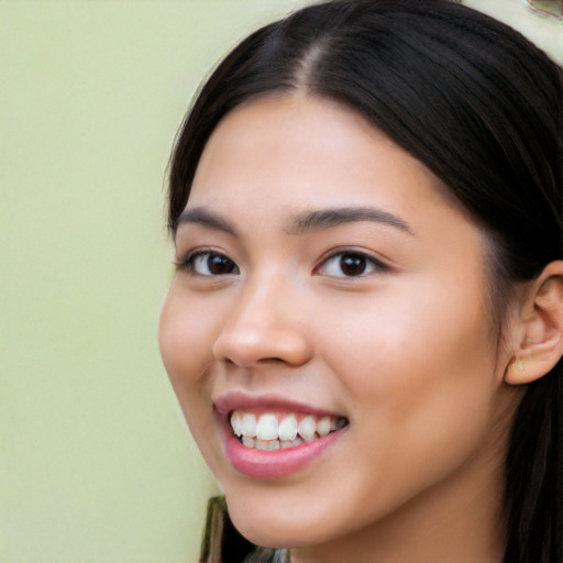 Joyful latino young-adult female with long  black hair and brown eyes