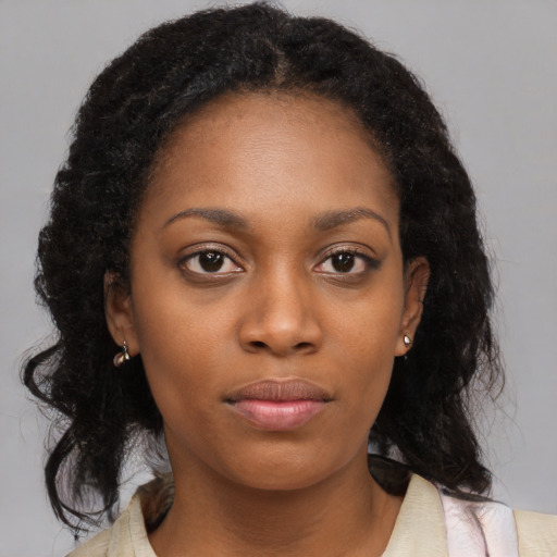 Neutral black young-adult female with medium  brown hair and brown eyes