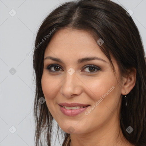 Joyful white young-adult female with long  brown hair and brown eyes