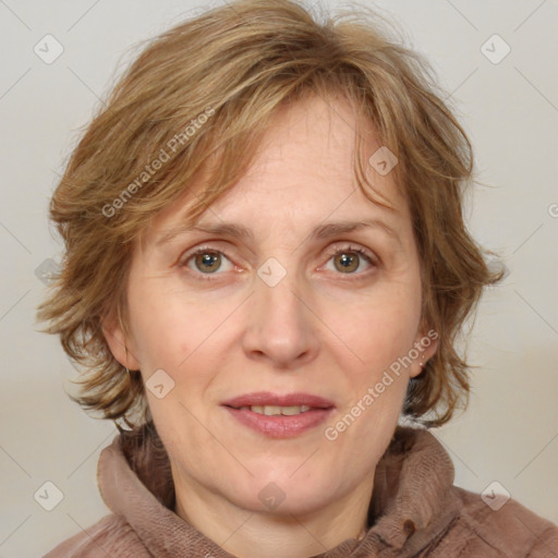 Joyful white adult female with medium  brown hair and blue eyes