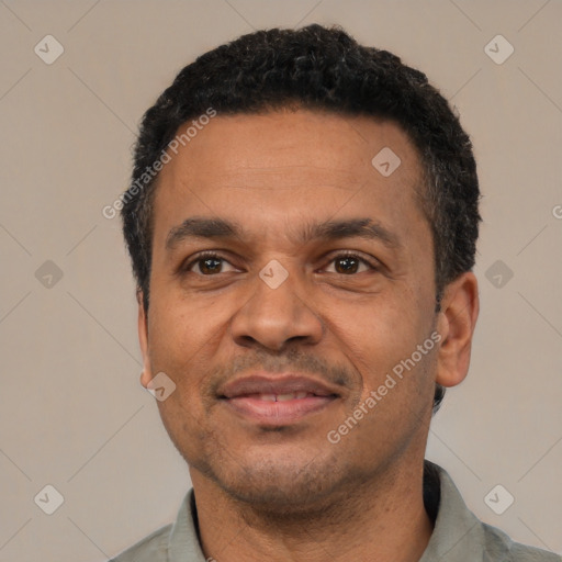 Joyful latino adult male with short  black hair and brown eyes