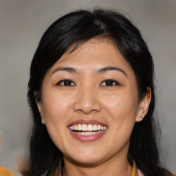 Joyful asian young-adult female with medium  black hair and brown eyes