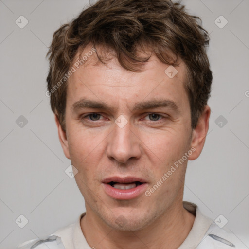 Joyful white adult male with short  brown hair and grey eyes