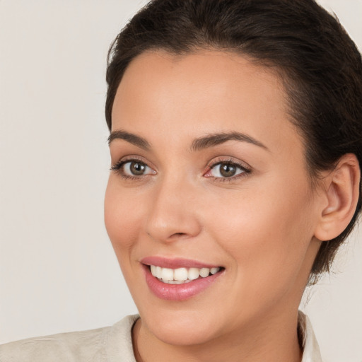 Joyful white young-adult female with medium  brown hair and brown eyes