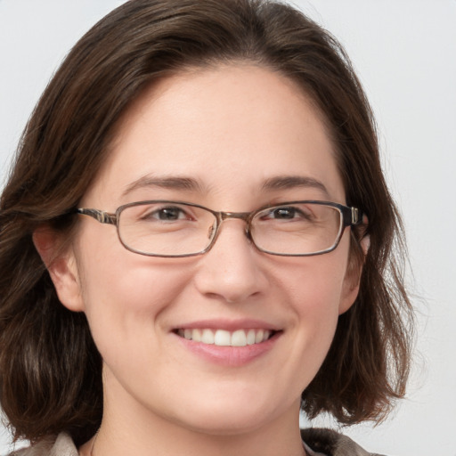 Joyful white young-adult female with medium  brown hair and grey eyes