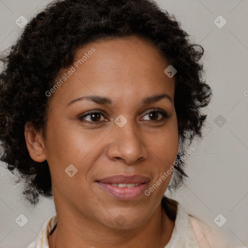 Joyful black adult female with medium  brown hair and brown eyes