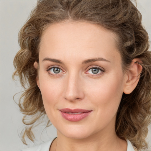 Joyful white young-adult female with medium  brown hair and green eyes