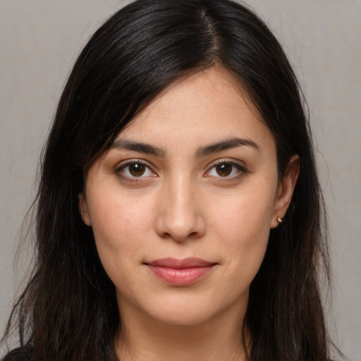 Joyful white young-adult female with long  brown hair and brown eyes