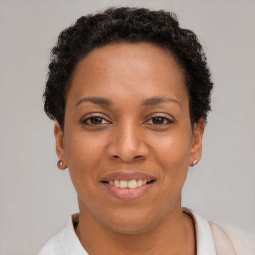 Joyful black young-adult female with short  brown hair and brown eyes