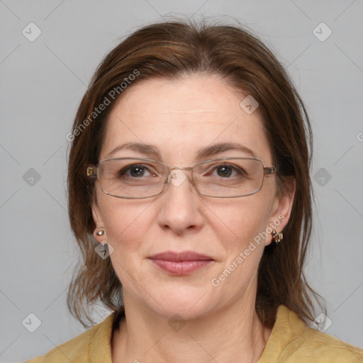 Joyful white adult female with medium  brown hair and blue eyes