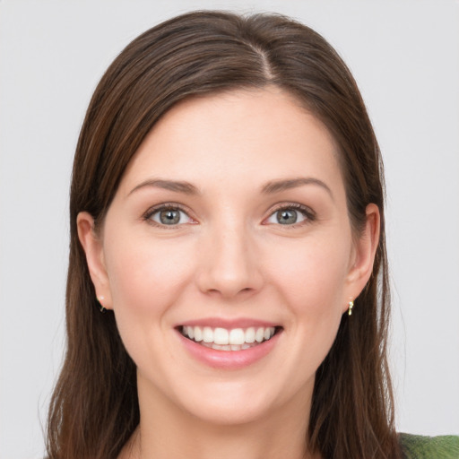 Joyful white young-adult female with long  brown hair and grey eyes