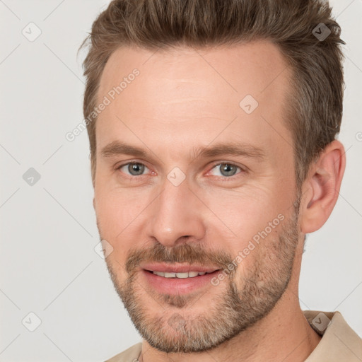 Joyful white adult male with short  brown hair and brown eyes