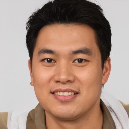 Joyful asian young-adult male with short  brown hair and brown eyes