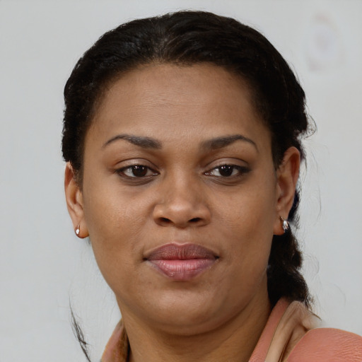 Joyful black young-adult female with short  brown hair and brown eyes