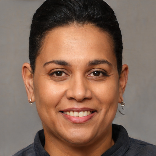 Joyful white adult female with short  brown hair and brown eyes