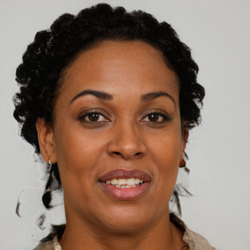 Joyful black adult female with short  brown hair and brown eyes