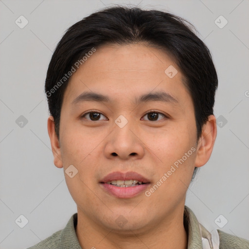 Joyful asian young-adult male with short  brown hair and brown eyes