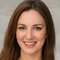 Joyful white young-adult female with long  brown hair and green eyes