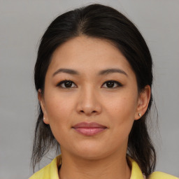 Joyful latino young-adult female with medium  brown hair and brown eyes