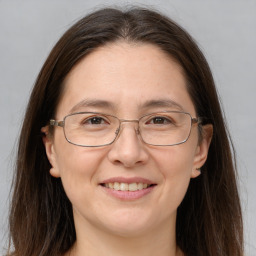 Joyful white adult female with long  brown hair and brown eyes