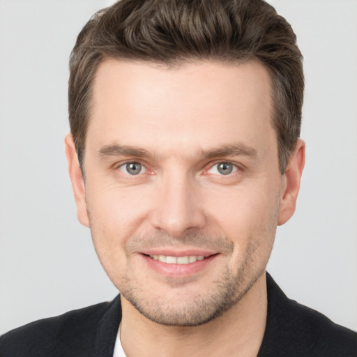 Joyful white young-adult male with short  brown hair and brown eyes