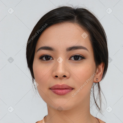 Joyful asian young-adult female with long  brown hair and brown eyes