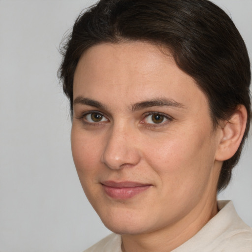 Joyful white young-adult female with short  brown hair and brown eyes