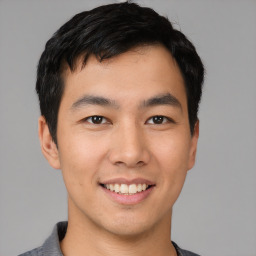 Joyful asian young-adult male with short  black hair and brown eyes