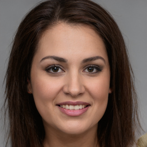 Joyful white young-adult female with long  brown hair and brown eyes