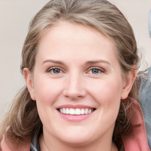 Joyful white young-adult female with medium  brown hair and blue eyes