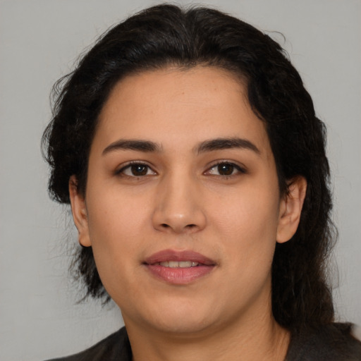 Joyful latino young-adult female with medium  brown hair and brown eyes
