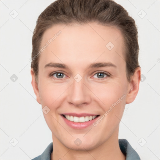 Joyful white young-adult female with short  brown hair and grey eyes