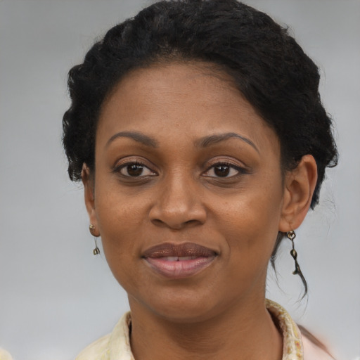 Joyful black adult female with short  brown hair and brown eyes