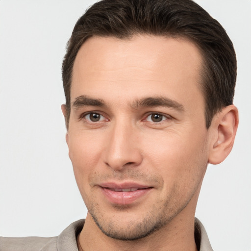 Joyful white young-adult male with short  brown hair and brown eyes