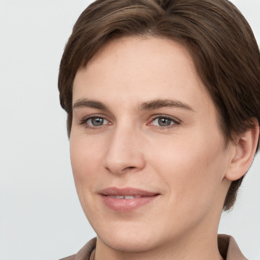 Joyful white young-adult female with short  brown hair and grey eyes