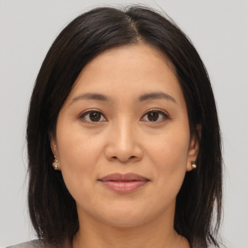 Joyful asian young-adult female with medium  brown hair and brown eyes