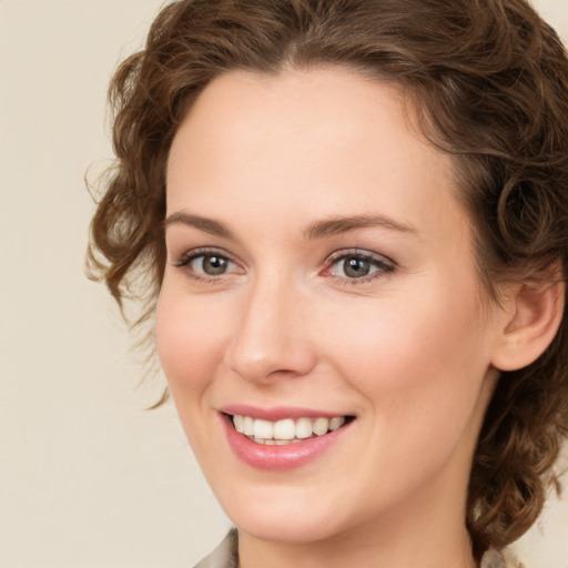 Joyful white young-adult female with medium  brown hair and green eyes