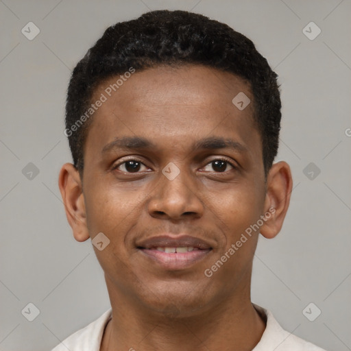 Joyful black young-adult male with short  brown hair and brown eyes