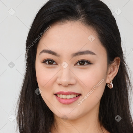 Joyful asian young-adult female with long  brown hair and brown eyes