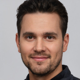 Joyful white young-adult male with short  brown hair and brown eyes