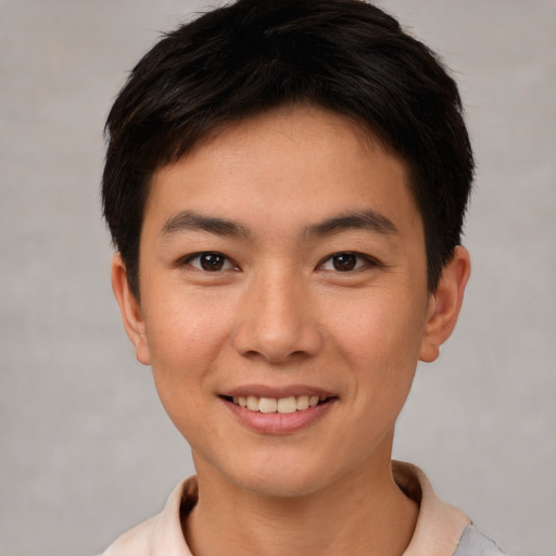 Joyful asian young-adult male with short  brown hair and brown eyes